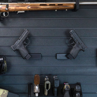 Thumbnail for Left & Right facing black plastic caliber specific  mag mounted pistol hangers installed on Assault Wall Tactical slat wall showcasing the adjustable mounting angles and directional mounts.