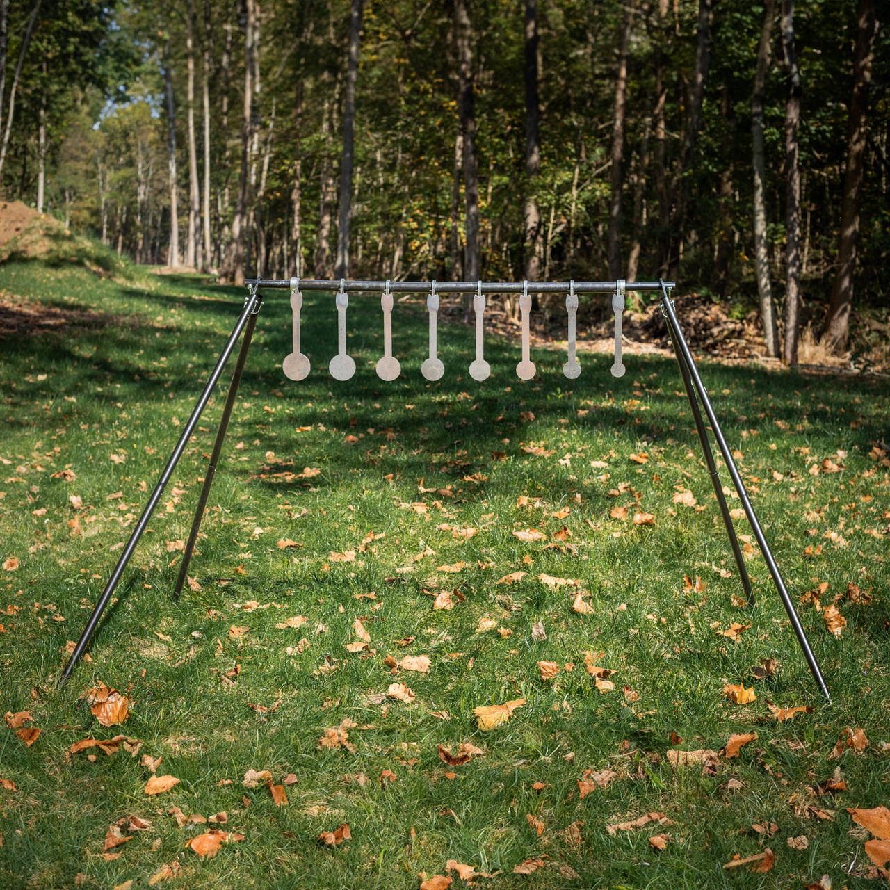 metal know your limits kyl targets assembled on conduit alternativer quick stand kit legs and crossbar in a wooded setting