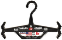 Thumbnail for The Caliber Armor Tough Hook is a black heavy-duty plastic hanger with a USA flag, “Veteran Owned Business,” and “Made in the USA” stickers—designed for plate carriers and tactical gear, featuring extra hooks for armor equipment.