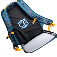 Thumbnail for A blue Vertx backpack with yellow straps is open, showing a black compartment holding the Caliber Armor CaliberX IIIA Body Armor Insert, designed for soft body armor protection. A stylized blue and white logo is visible inside.