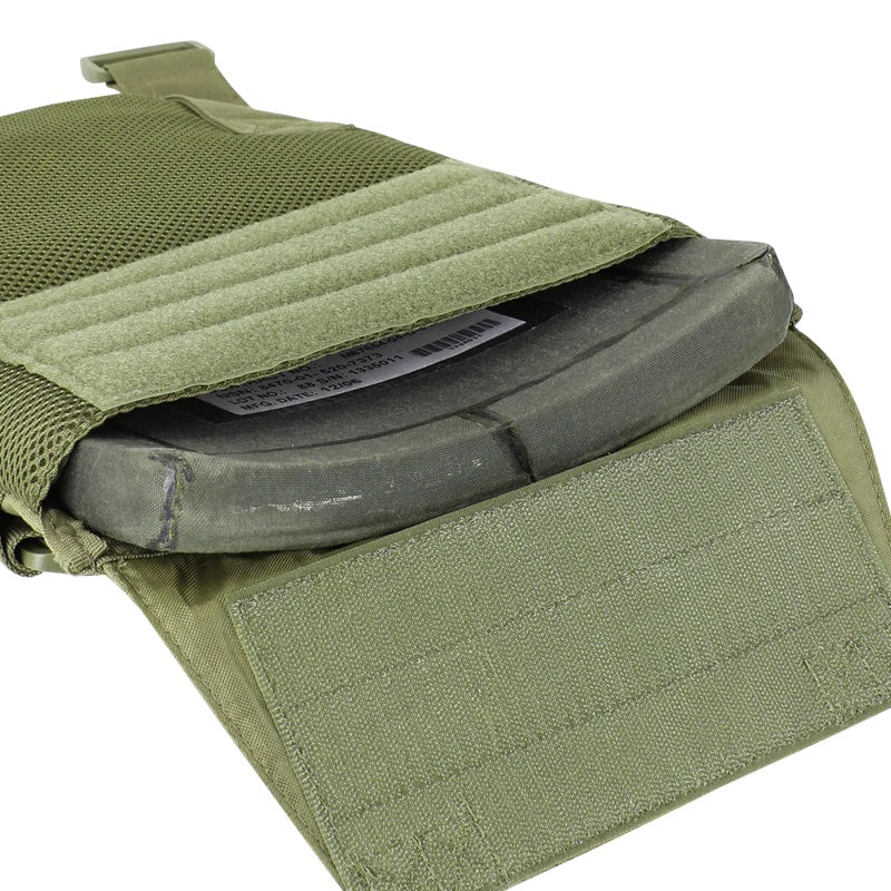 A close-up of the Caliber Armor Sentry Plate Carrier, a green tactical vest with adjustable sizing, showing its open Velcro pouch that reveals a black ballistic plate inside.