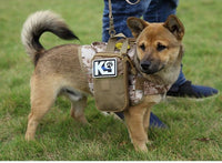 Thumbnail for A dog wearing a Tactical Scorpion Gear D2 Compact Canine Dog K9 Camo MOLLE Military Training Vest Harness with a pouch standing on grass.