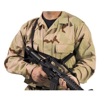 Thumbnail for A person in camouflage military uniform holding an Elite Survival Systems Quick-Adapt Tactical Sling, cropped to show only from the neck down.