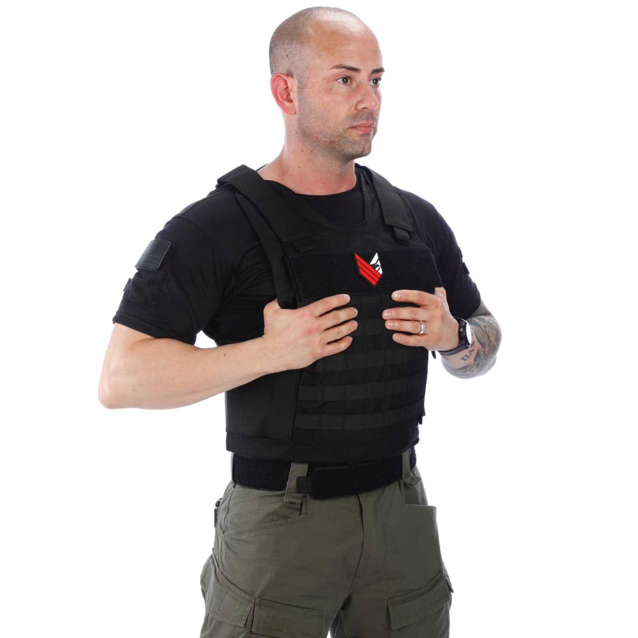 A man holding a Body Armor Direct All Star Tactical Enhanced Multi-Threat Vest in front of a white background.