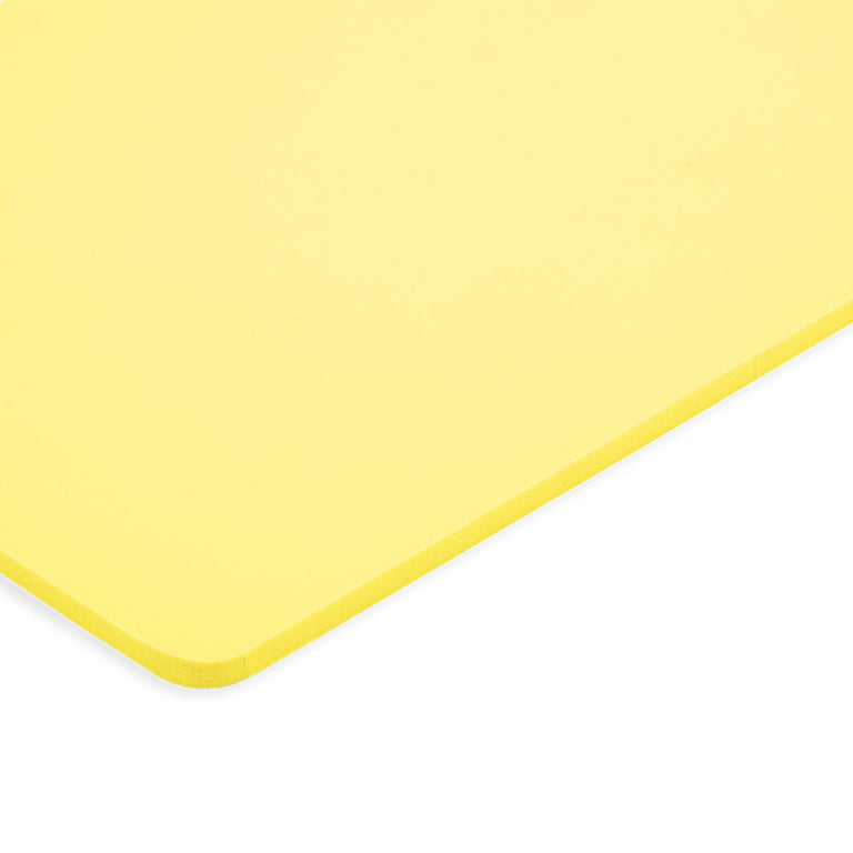A yellow plastic Caliber Armor Extreme Impact Trauma Pad Shooters Cut - 8 x 10 cutting board on a white surface.
