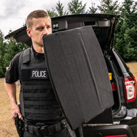 Thumbnail for A police officer standing in the trunk of a Spartan Armor Systems SaintPro Ballistic Shield Level IIIA SUV.