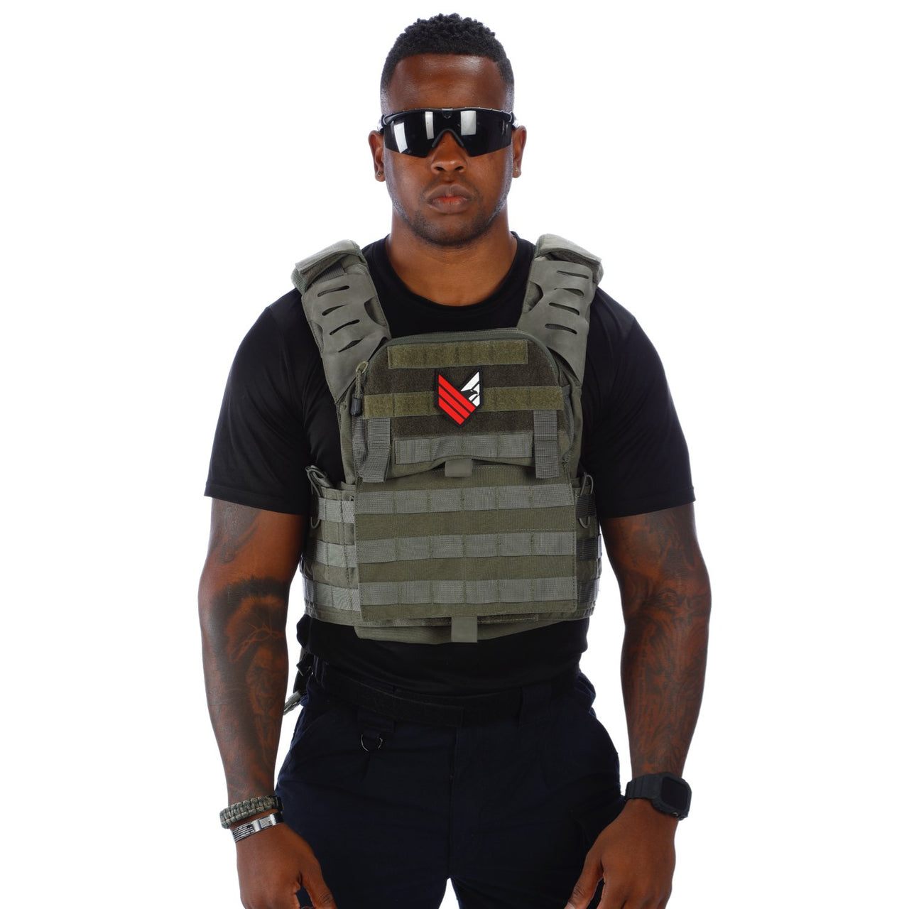 A man wearing a Body Armor Direct Victory Plate Carrier Deluxe Edition and sunglasses stands confidently against a white background.