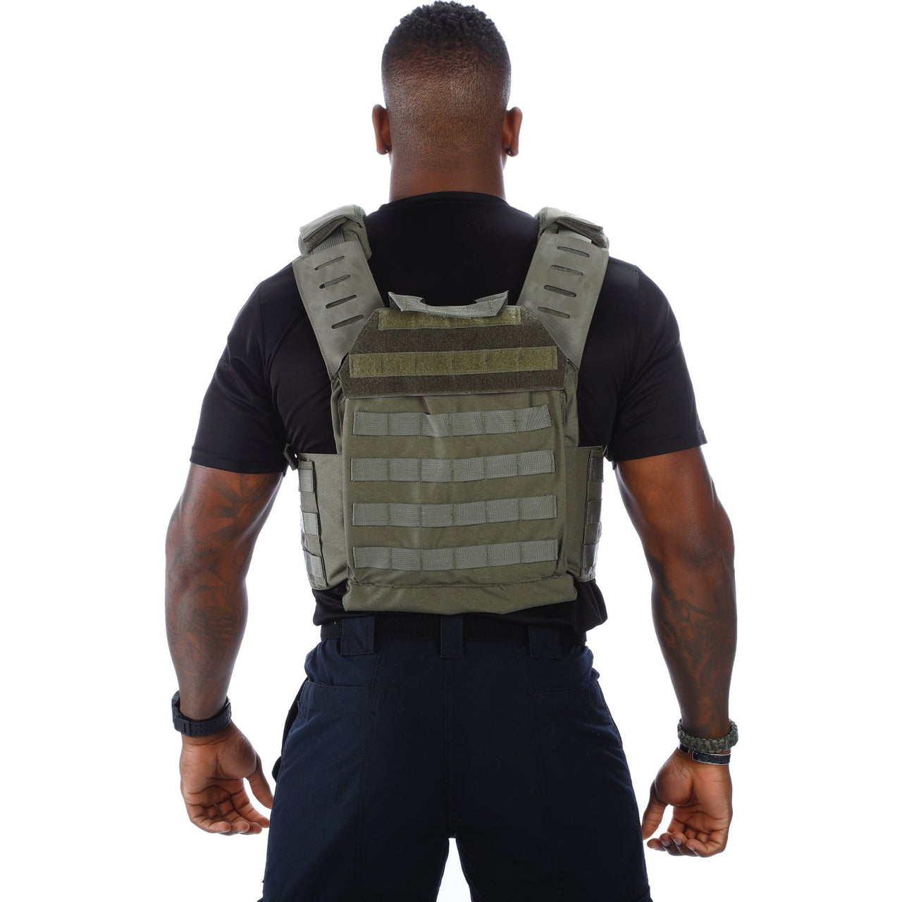 Rear view of a man wearing a black Body Armor Direct Victory Plate Carrier Deluxe Edition with visible muscular arms and a watch, isolated on a white background.