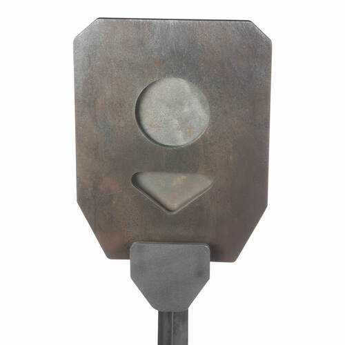 A Spartan Armor Systems Head Shot Gut Shot metal plate with a hole in it.