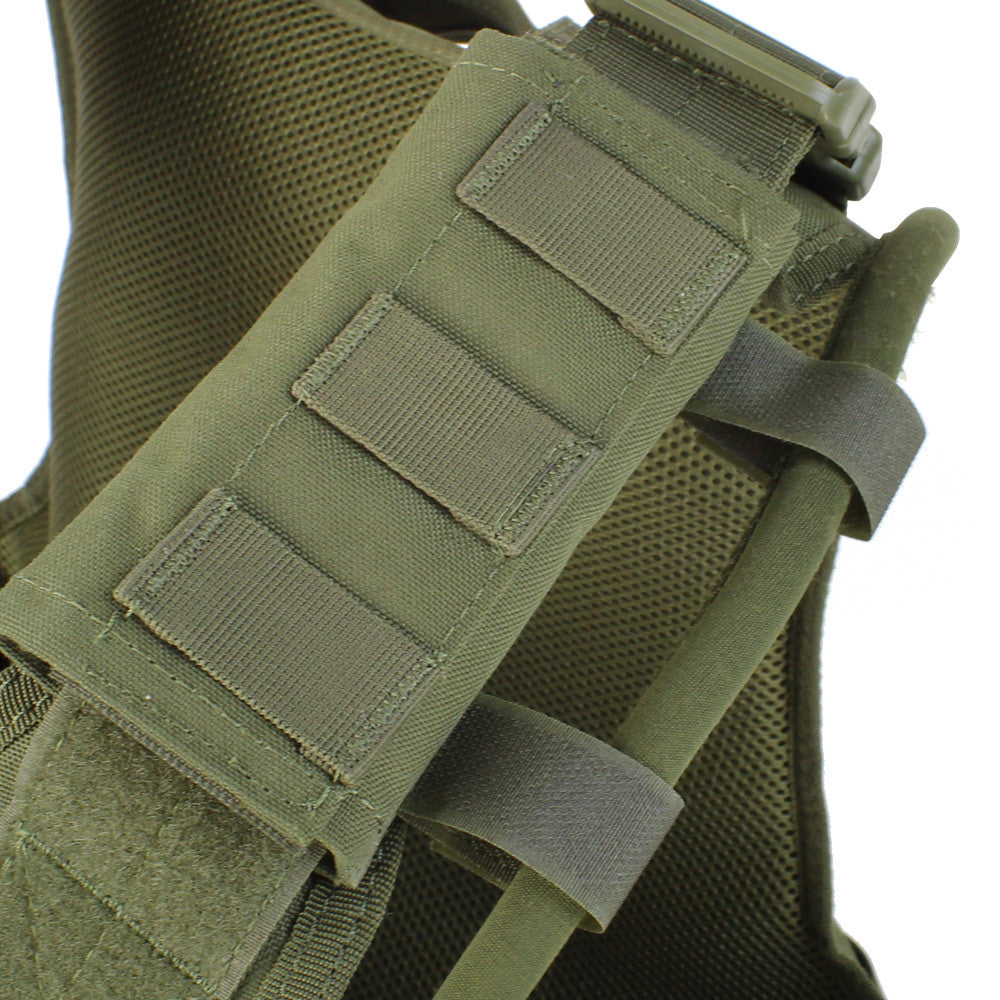 Close-up of a green tactical backpack strap with molle webbing and a buckle on a Spartan Armor Systems Condor Defender Plate Carrier.