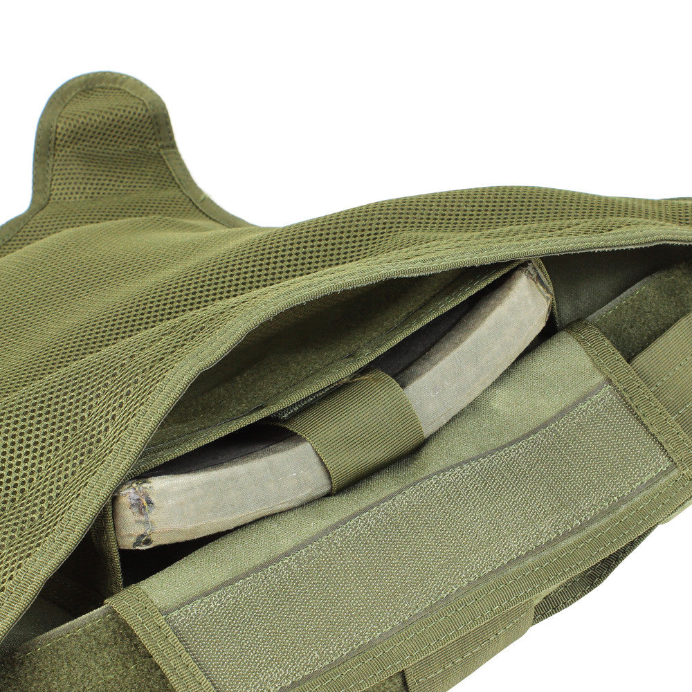 Close-up of an open green Spartan Armor Systems Condor Defender Plate Carrier revealing internal pockets and straps, set against a white background.
