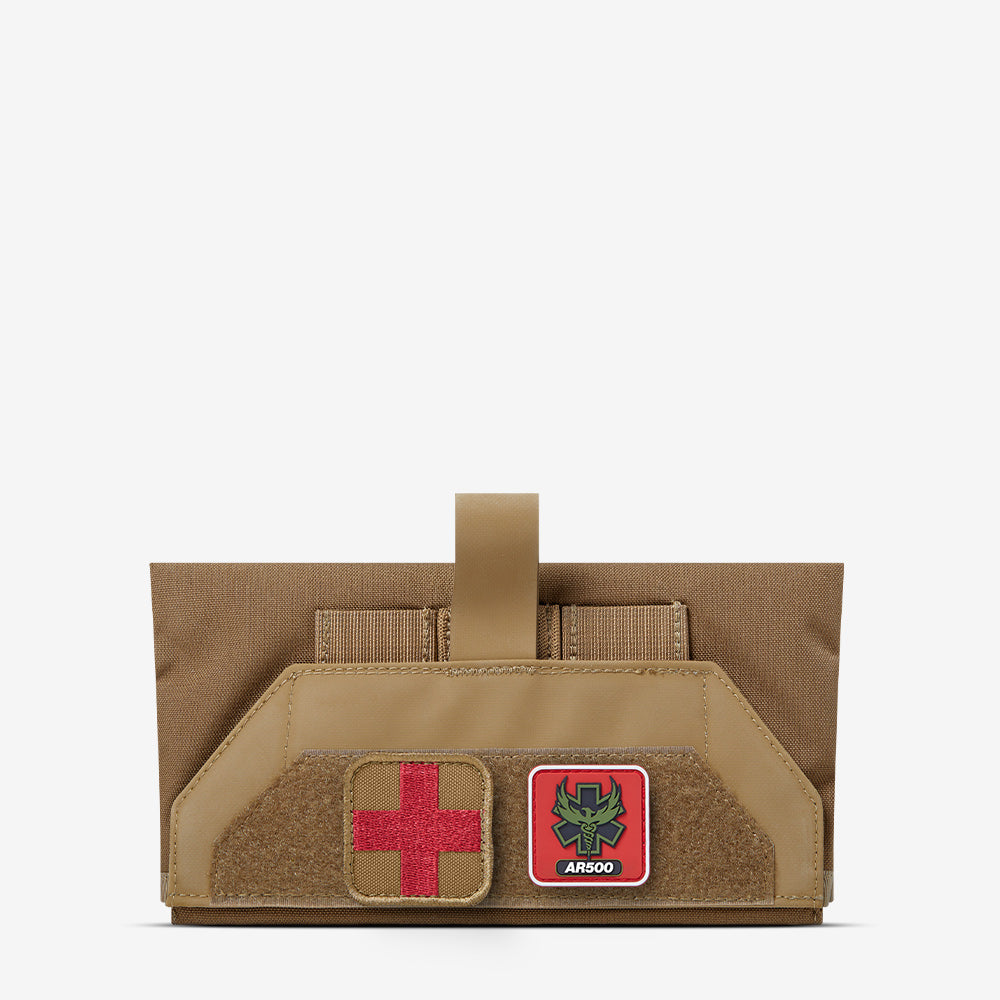 A AR500 Armor tan pouch with a red cross on it.