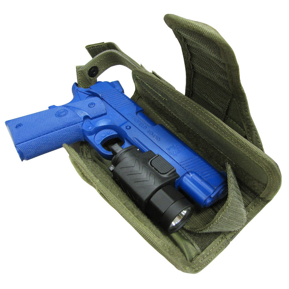 A blue training pistol inside a partially open green Spartan Armor Systems Condor HT Holster on a white background.