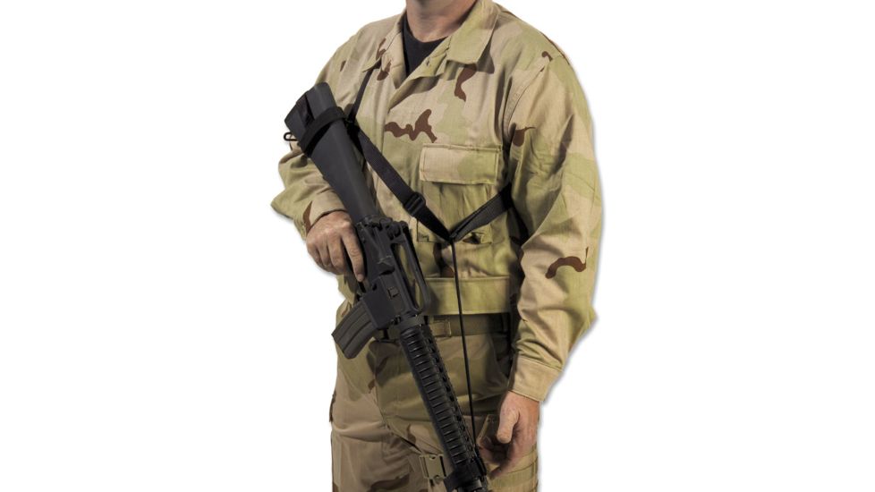 A soldier in camouflage uniform holding an Elite Survival Systems Quick-Adapt Tactical Sling, standing against a plain white background.