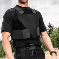 Thumbnail for A man in a black shirt standing in a field wearing the Spartan Armor Systems Concealable IIIA Certified Wraparound Vest.